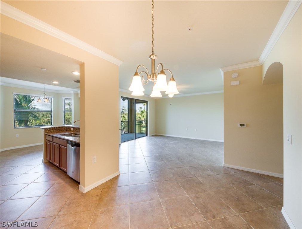 9727 Acqua Court, Unit 413 Naples, FL 34113 - Photo 9 of 35 a view of a kitchen with granite countertop a sink and dishwasher a oven with wooden floor