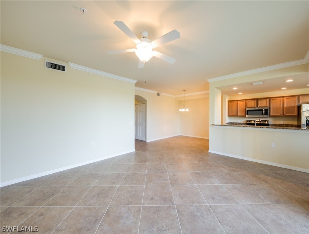 9727 Acqua Court, Unit 413 Naples, FL 34113 - Photo 10 of 35 a view of an empty room and kitchen view