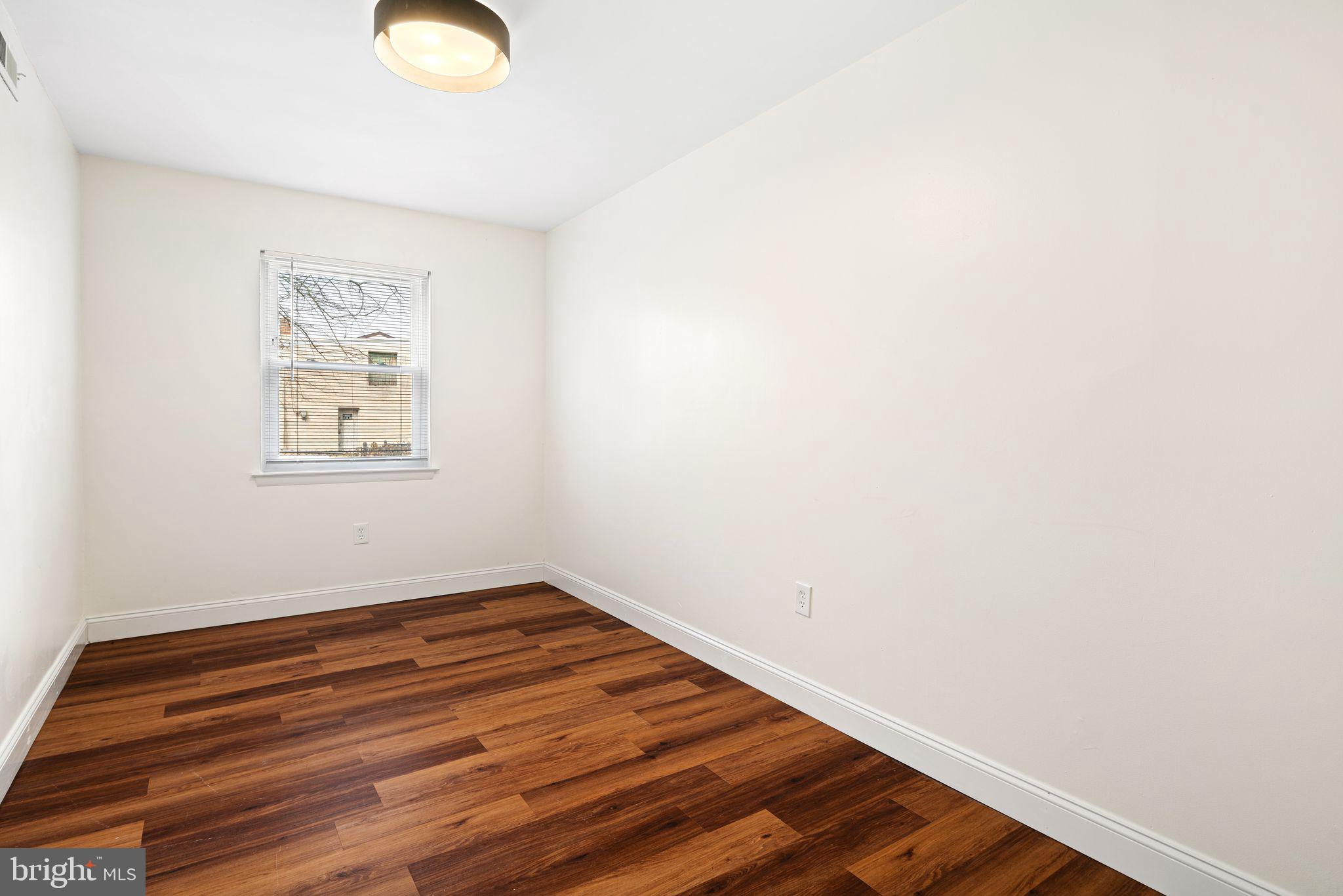 7926 Cottage Street Philadelphia, PA 19136 - Photo 11 of 29 an empty room with wooden floor and window