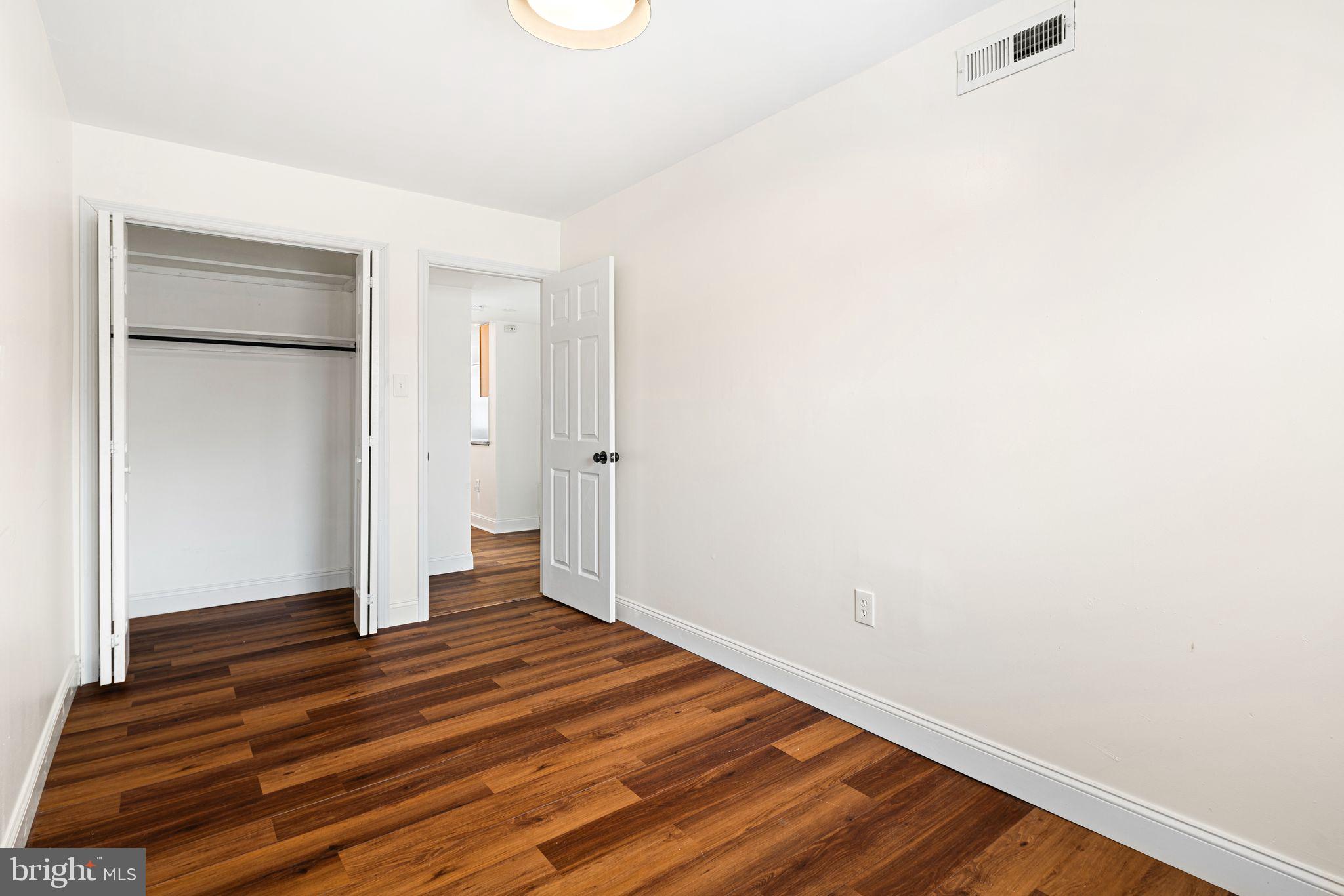 7926 Cottage Street Philadelphia, PA 19136 - Photo 12 of 29 a view of an empty room with wooden floor and a bathroom