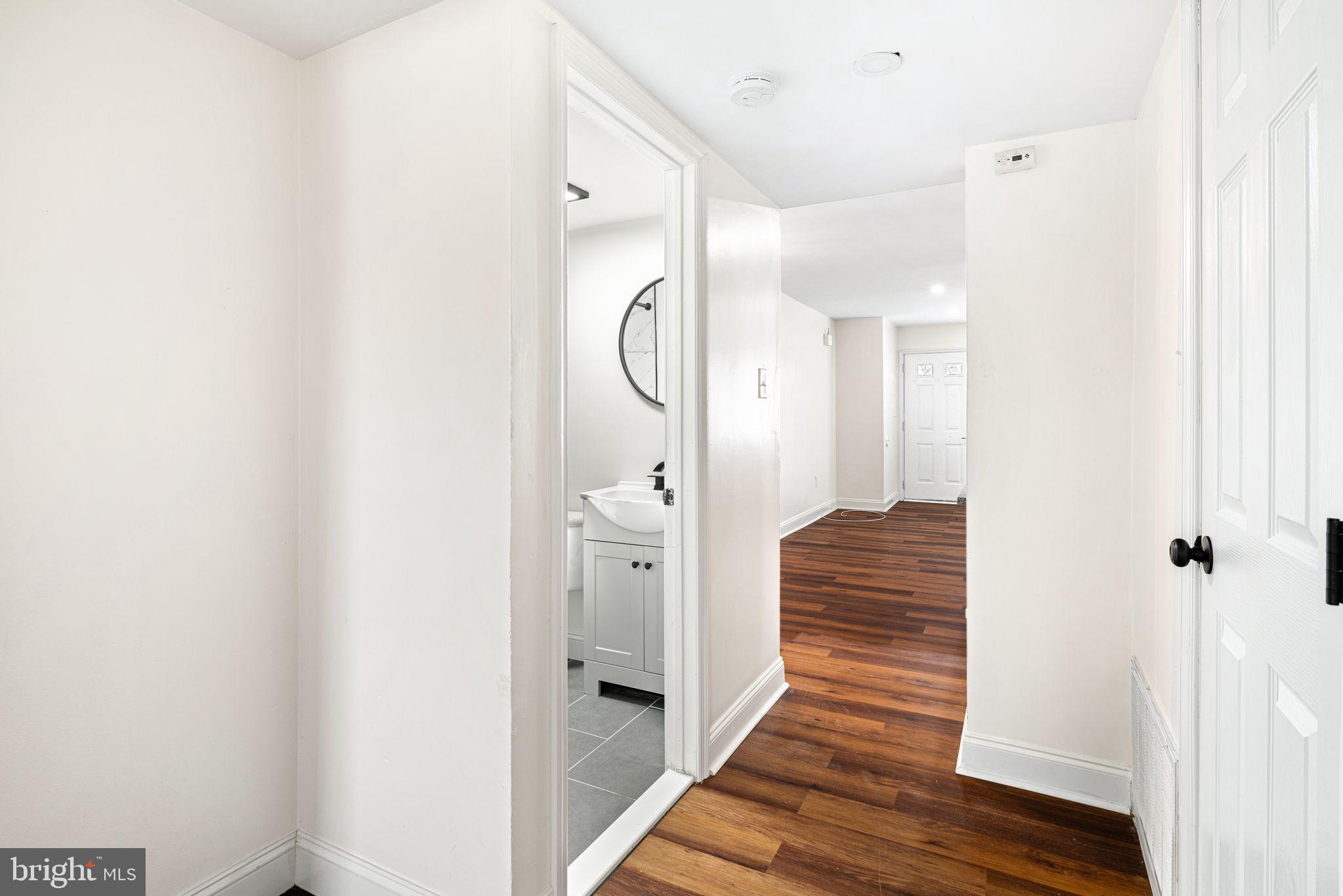 7926 Cottage Street Philadelphia, PA 19136 - Photo 13 of 29 a view of a hallway with wooden floor and staircase