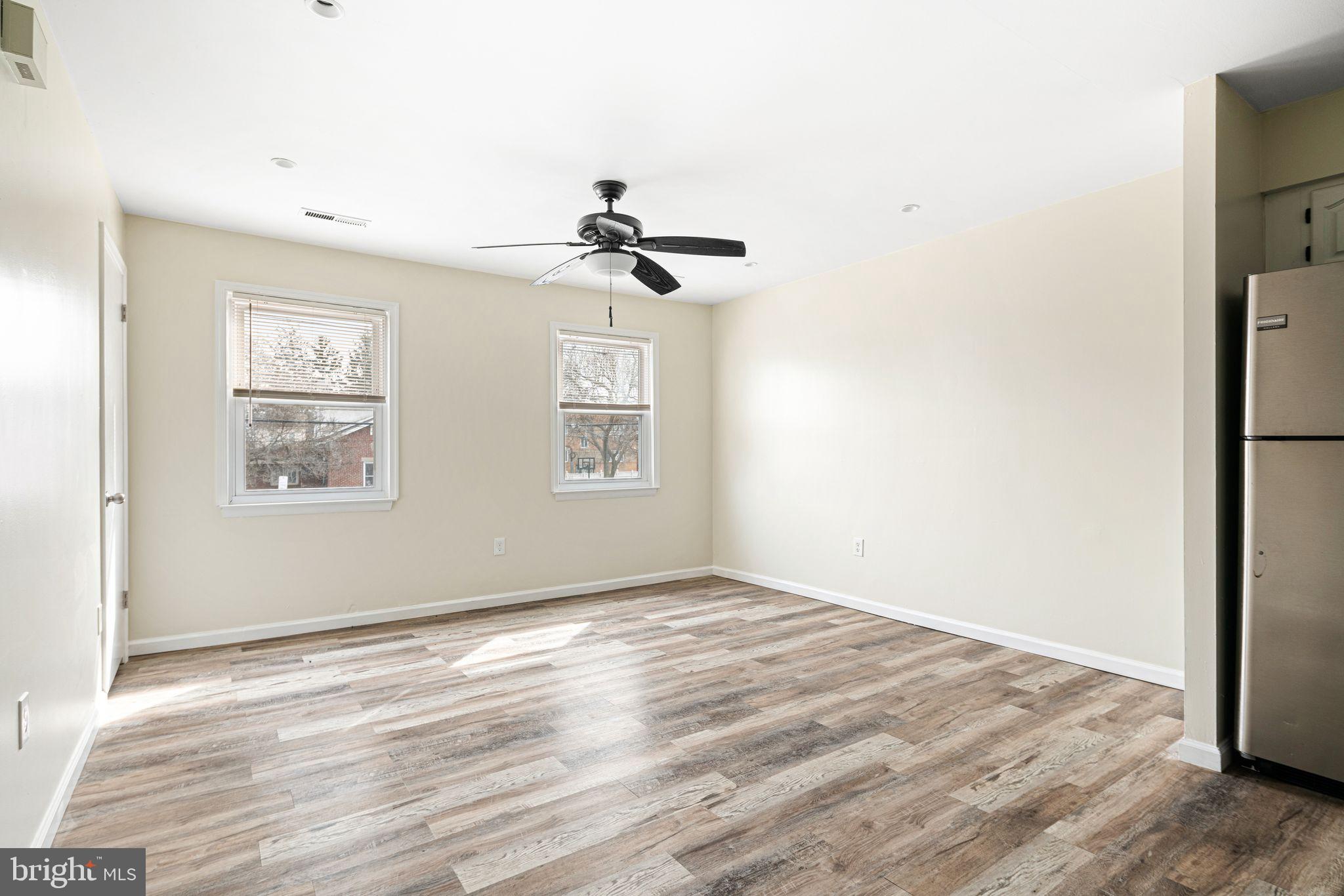 7926 Cottage Street Philadelphia, PA 19136 - Photo 18 of 29 a view of empty room with wooden floor and fan