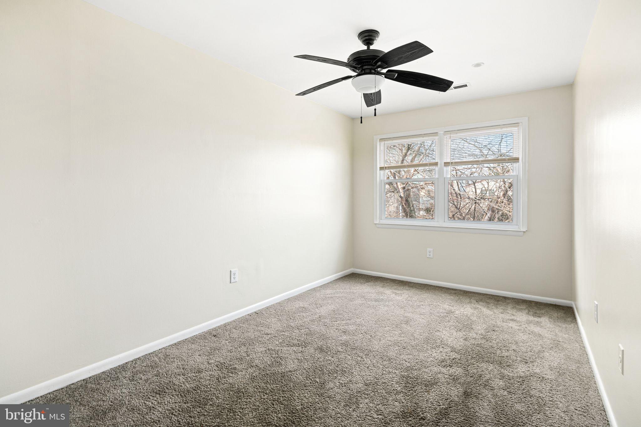 7926 Cottage Street Philadelphia, PA 19136 - Photo 23 of 29 an empty room with window and ceiling fan