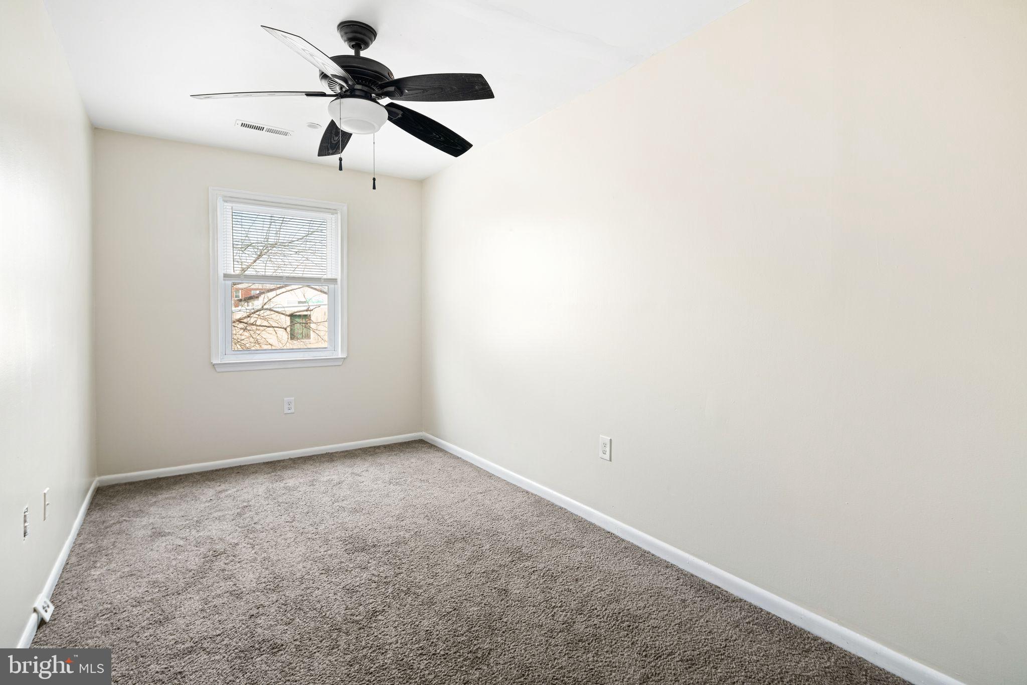 7926 Cottage Street Philadelphia, PA 19136 - Photo 25 of 29 an empty room with a window and a ceiling fan