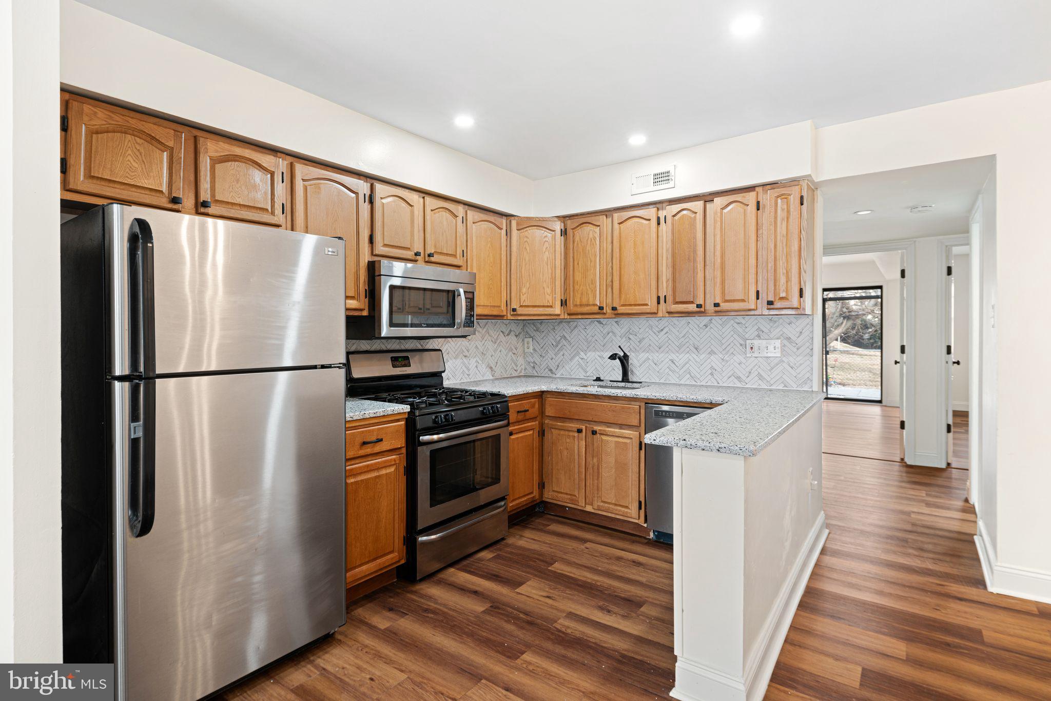 7926 Cottage Street Philadelphia, PA 19136 - Photo 6 of 29 a kitchen with stainless steel appliances granite countertop a refrigerator stove and sink