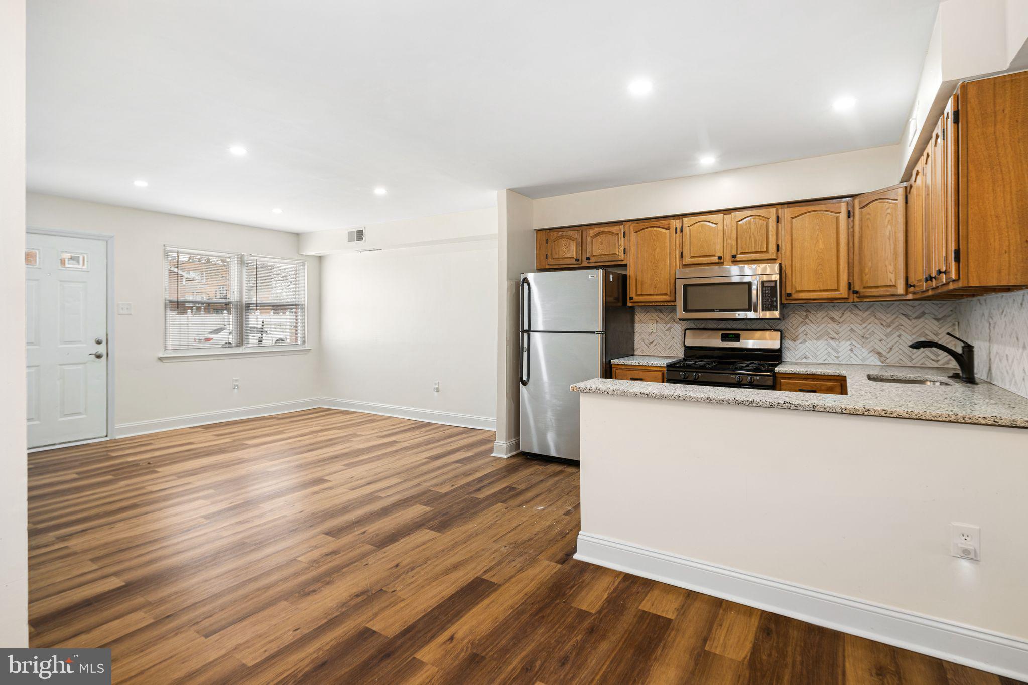 7926 Cottage Street Philadelphia, PA 19136 - Photo 8 of 29 a kitchen with stainless steel appliances a refrigerator sink and microwave