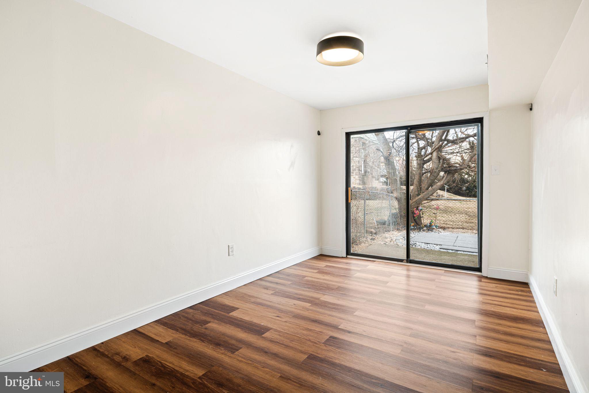 7926 Cottage Street Philadelphia, PA 19136 - Photo 9 of 29 an empty room with wooden floor and windows