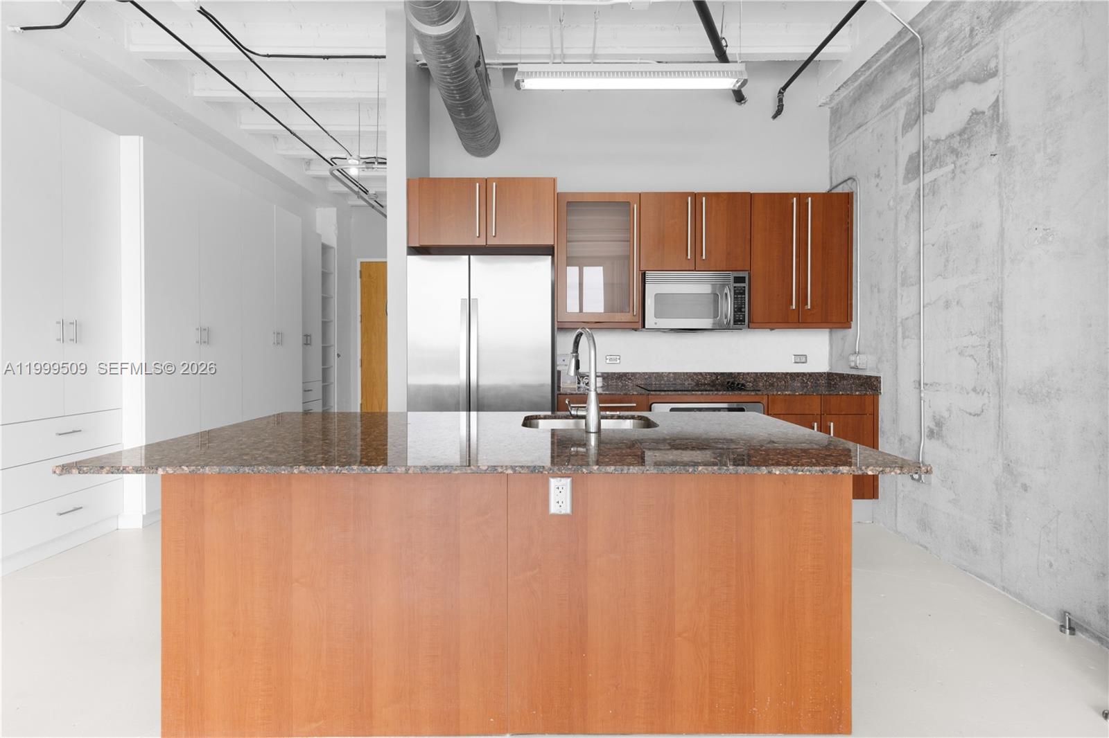 8101 Biscayne Boulevard, Unit R414 Miami, FL 33138 - Photo 15 of 27 a kitchen with stainless steel appliances granite countertop a sink a refrigerator and a granite counter tops