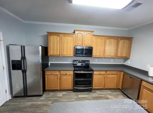a kitchen with a sink cabinets and wooden floor