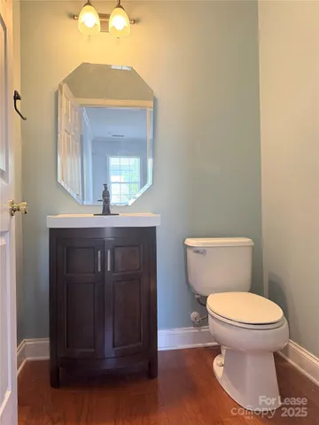 a view of an empty room with a chandelier fan