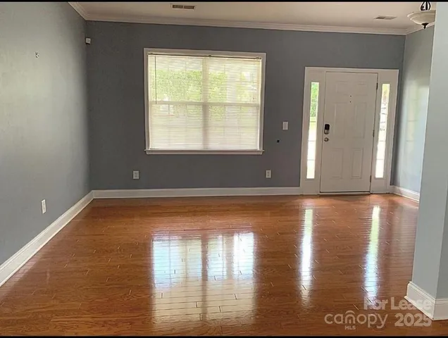 a view of livingroom with window fireplace and windows
