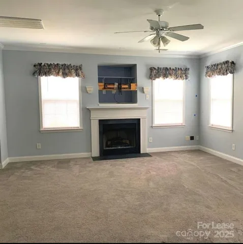 a large kitchen with stainless steel appliances kitchen island granite countertop a stove top oven a sink dishwasher a dining table and chairs with wooden floor