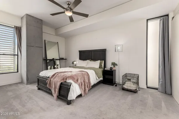 a spacious bedroom with a bed and a chandelier