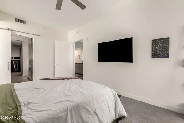 a bedroom with a bed and a flat screen tv