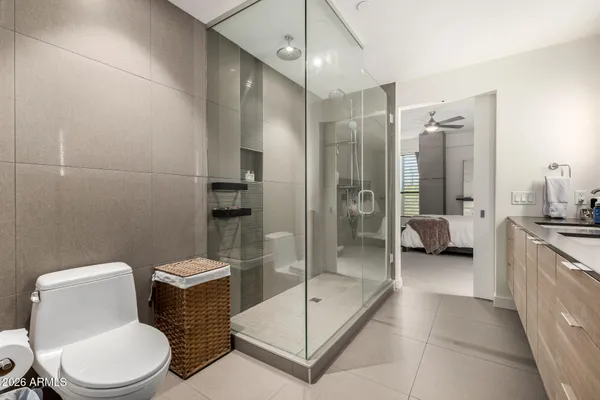 a bathroom with a toilet a sink and glass door