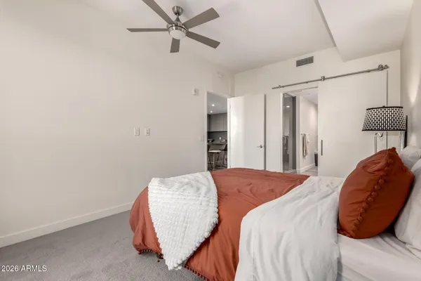 a bedroom with a bed and a chair