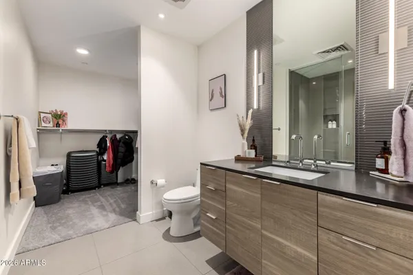 a bathroom with a granite countertop sink a toilet and a mirror