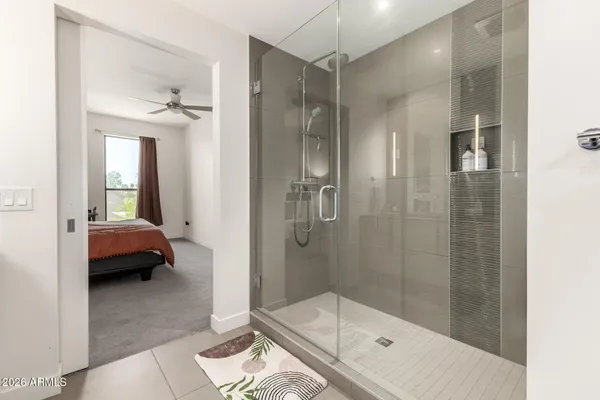 a bathroom with a tub shower and sink