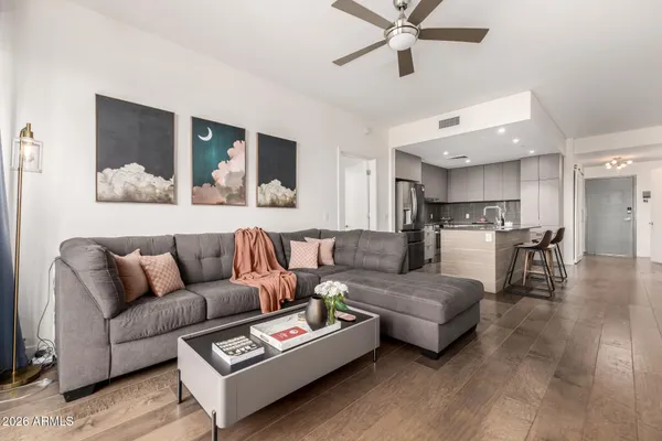 a living room with furniture and view of kitchen
