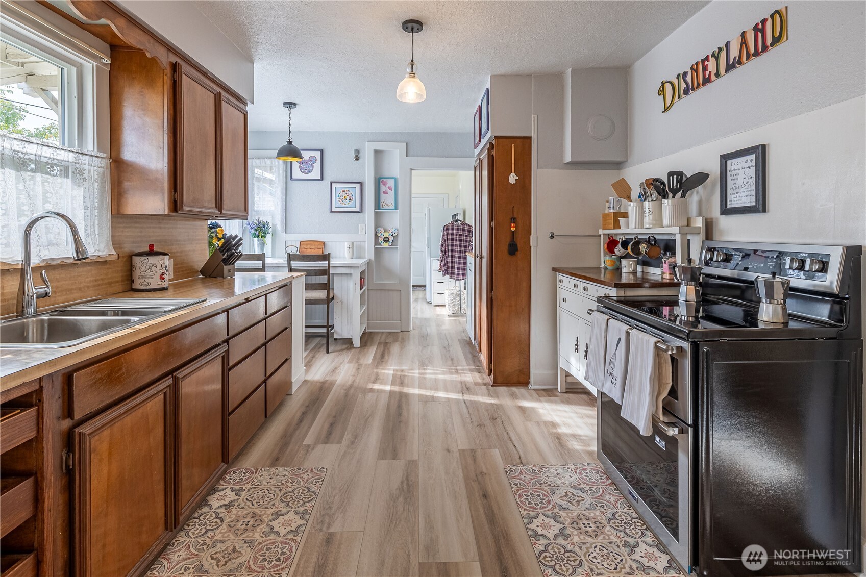 318 4th Street Southwest Puyallup, WA 98371 - Photo 13 of 40 a kitchen with stainless steel appliances a refrigerator sink and wooden cabinets