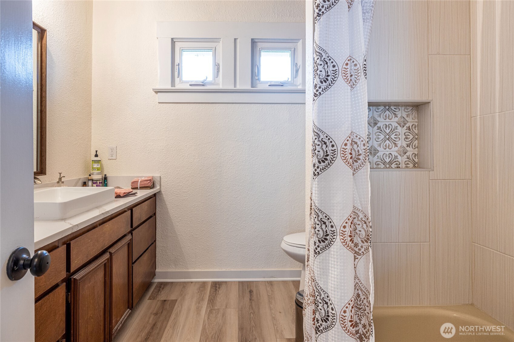 318 4th Street Southwest Puyallup, WA 98371 - Photo 20 of 40 a bathroom with a sink a mirror and shower