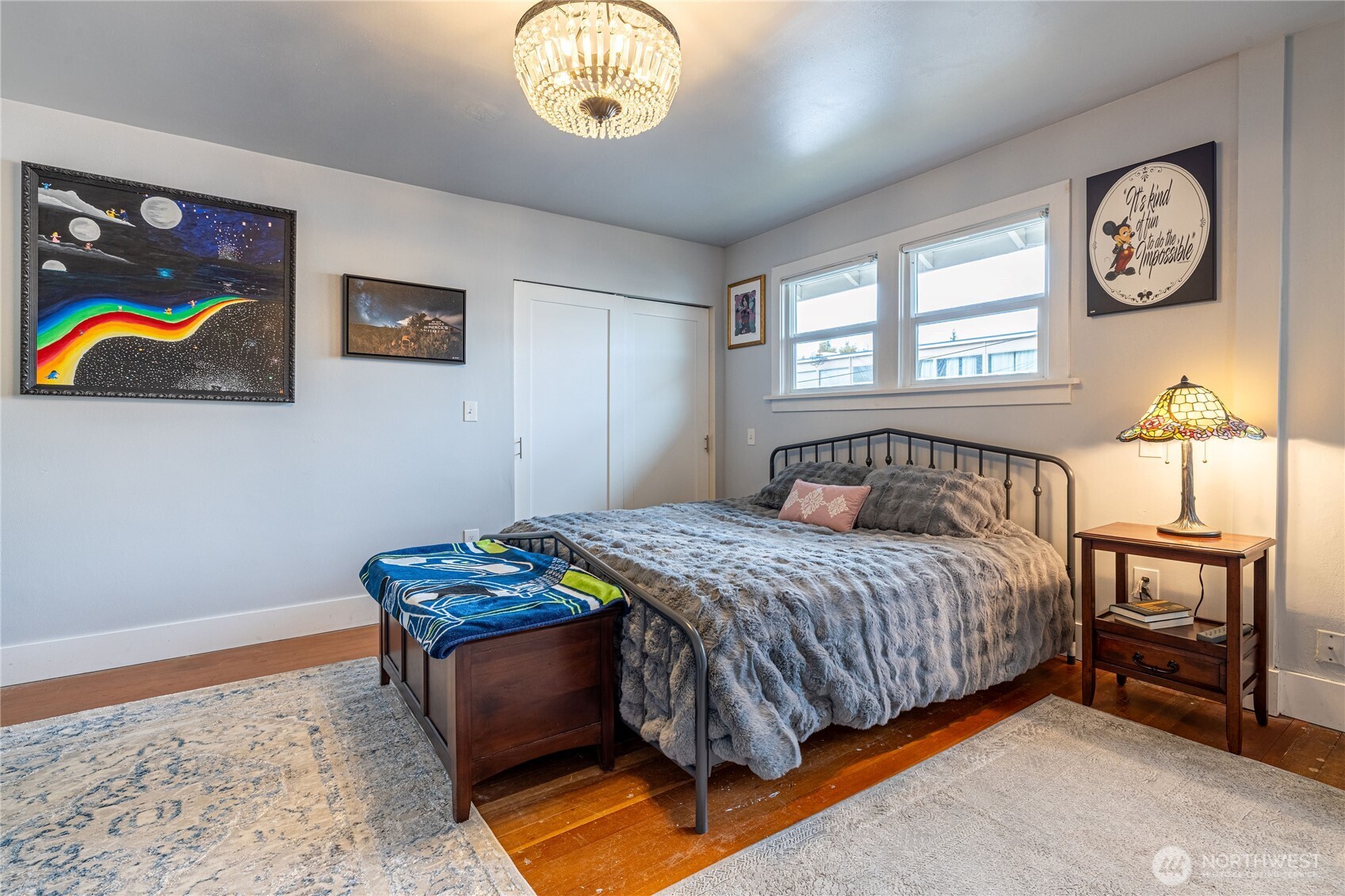 318 4th Street Southwest Puyallup, WA 98371 - Photo 23 of 40 a bedroom with a bed and a chandelier