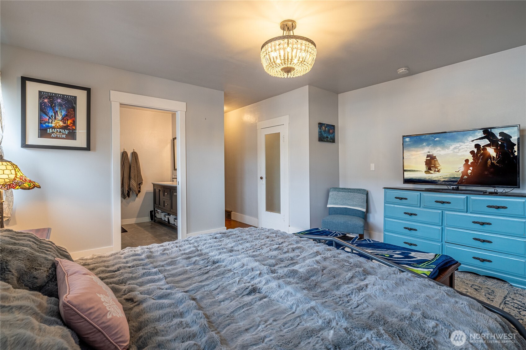 318 4th Street Southwest Puyallup, WA 98371 - Photo 24 of 40 a bedroom with a bed and a chandelier