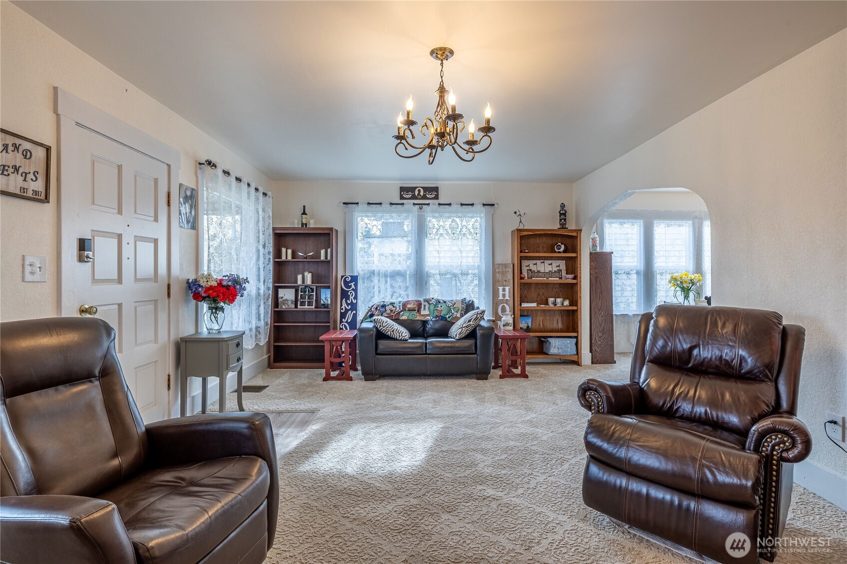 318 4th Street Southwest Puyallup, WA 98371 - Photo 8 of 40 a living room with furniture and a chandelier