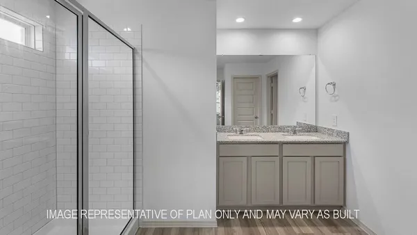 a bathroom with a granite countertop sink a mirror and a shower