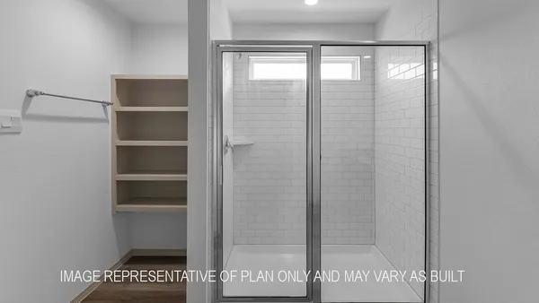a bathroom with a glass shower door