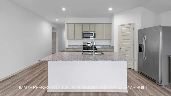 a view of kitchen with stainless steel appliances granite countertop refrigerator sink and stove