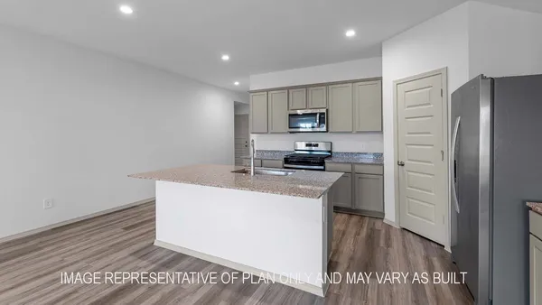 a kitchen with kitchen island a sink stainless steel appliances and cabinets