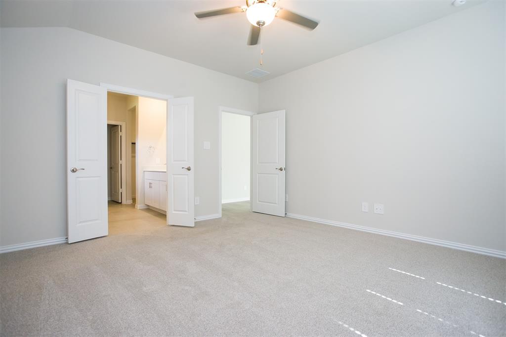404 Castle Road Sherman, TX 75092 - Photo 8 of 25 an empty room with chandelier fan and windows