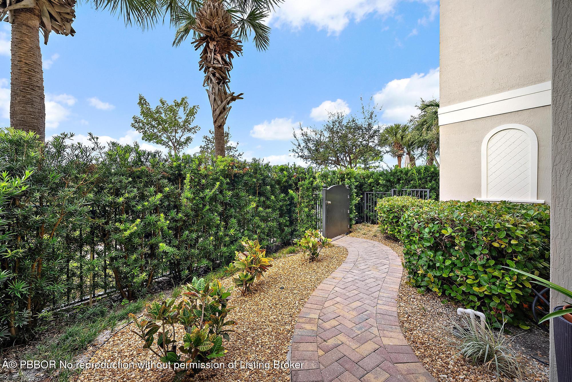 138 Tierra Lane, Unit 6 Jupiter, FL 33477 - Photo 30 of 41 a view of a pathway with a yard