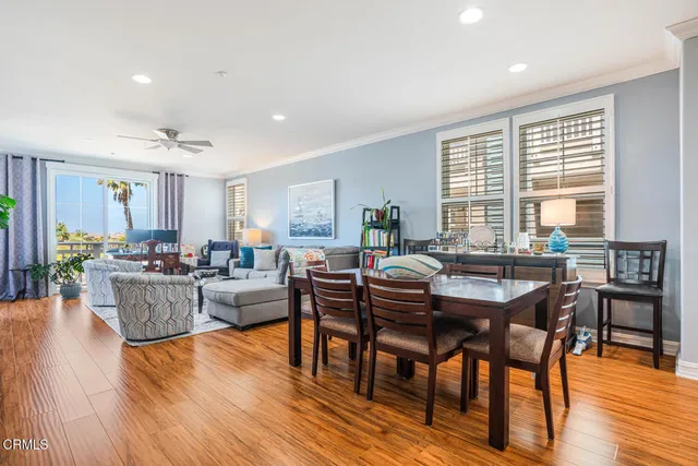 a dining room with furniture window and wooden floor