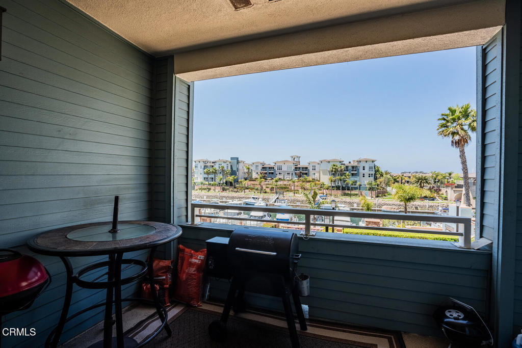 1541 Windshore Way Oxnard, CA 93035 - Photo 18 of 42 a view of a dining table with chairs and a table in a balcony