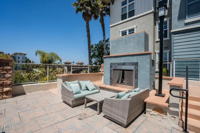 a outdoor space with patio the couches and a fireplace
