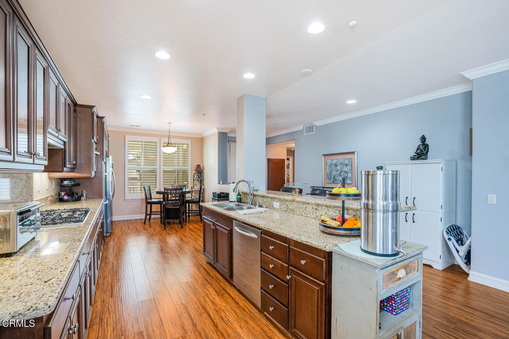 1541 Windshore Way Oxnard, CA 93035 - Photo 8 of 42 a kitchen with stainless steel appliances granite countertop a stove and a wooden floors