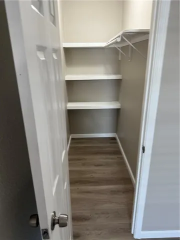 a view of walk in closet with empty racks