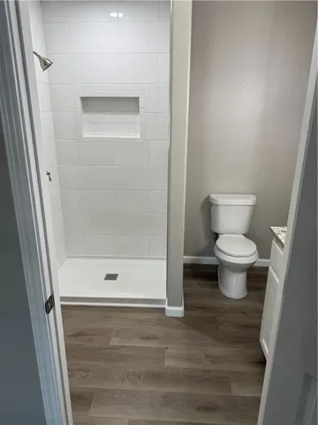 a bathroom with a toilet and a shower