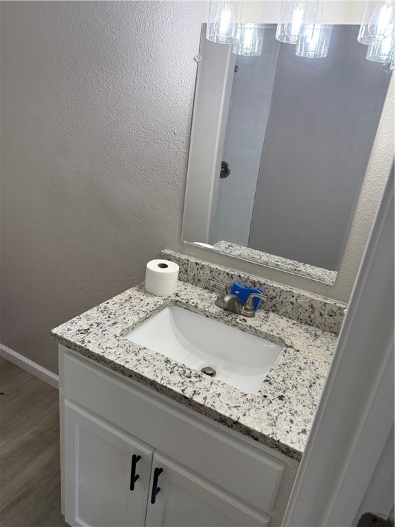 512 Wheeler Street Three Rivers, TX 78071 - Photo 16 of 19 a bathroom with a granite countertop sink and a mirror