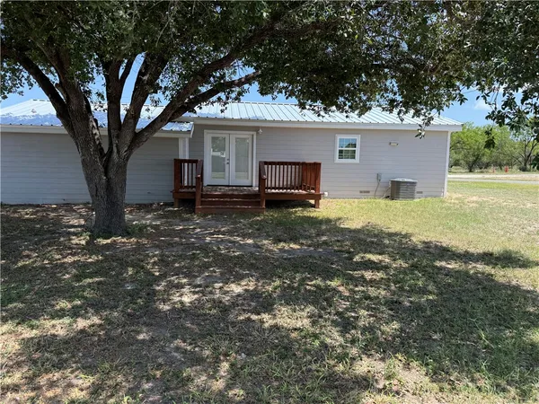 a house that has a tree in front of the house