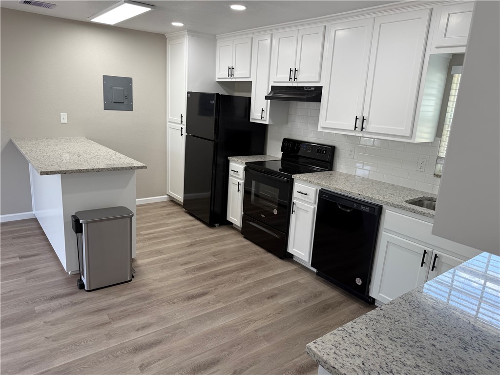 512 Wheeler Street Three Rivers, TX 78071 - Photo 4 of 19 a kitchen with a refrigerator and a stove top oven