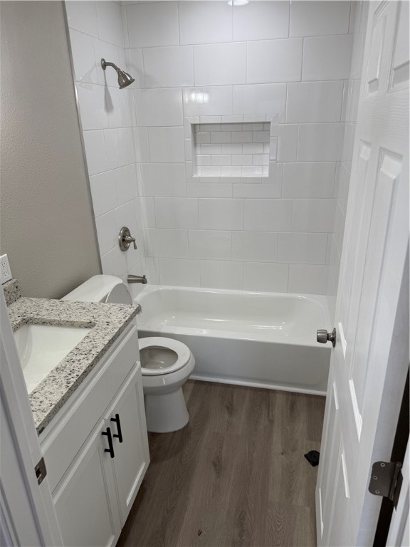 512 Wheeler Street Three Rivers, TX 78071 - Photo 7 of 19 a bathroom with a granite countertop sink a toilet and bathtub