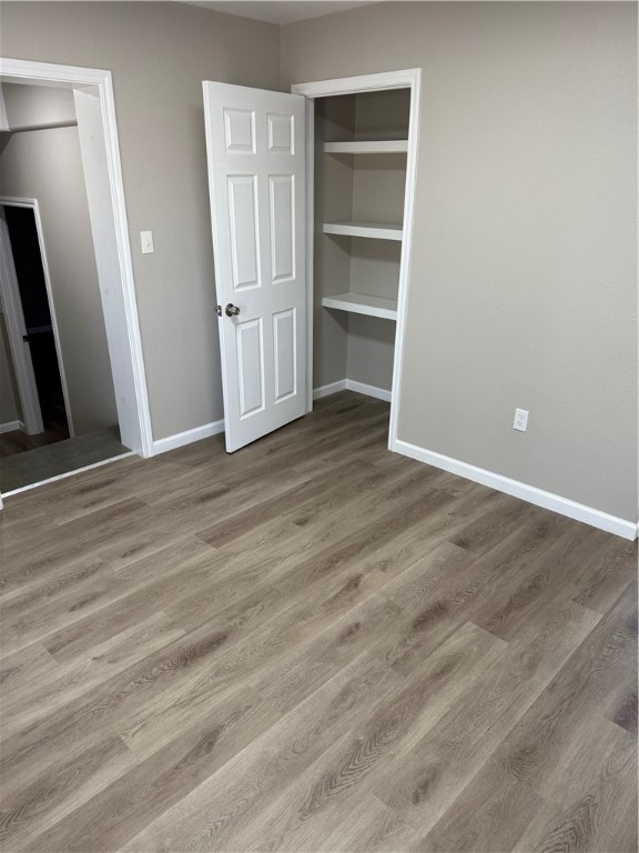 512 Wheeler Street Three Rivers, TX 78071 - Photo 9 of 19 a view of an empty room with wooden floor and a window