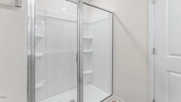a bathroom with a glass shower door