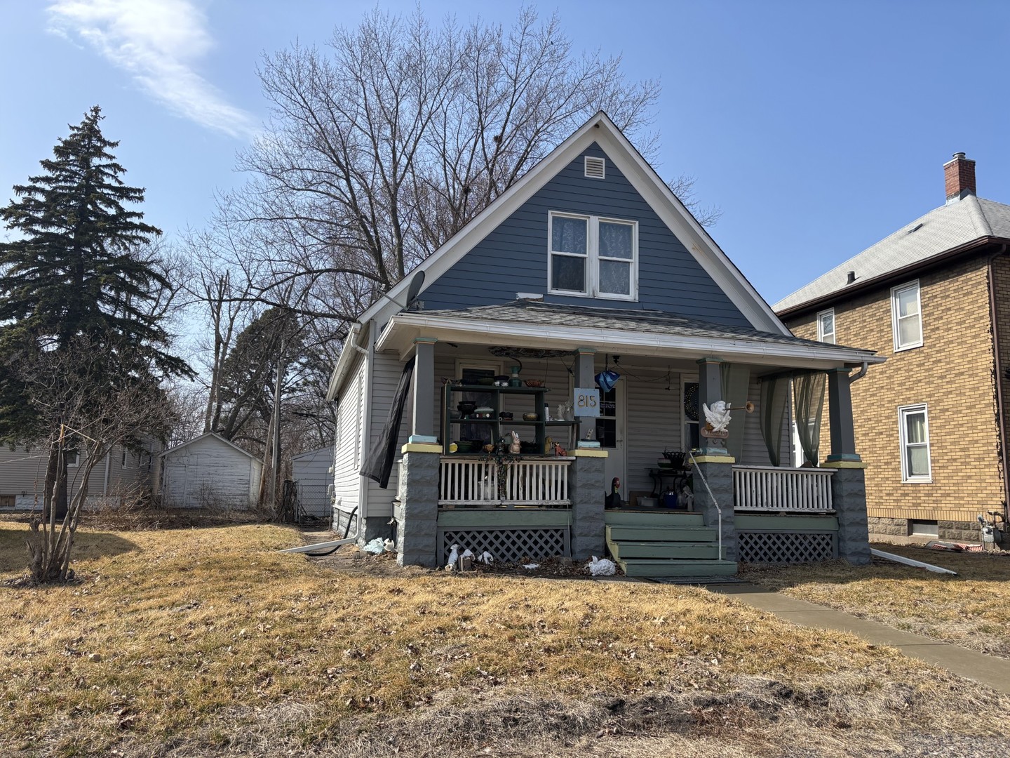 815 20th Street East Moline, IL 61244 - Photo 3 of 12 a front view of a house with a yard covered in snow