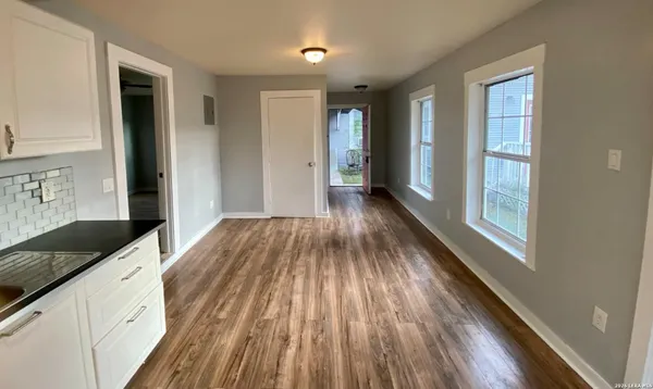 a view of a hallway view with wooden floor and staircase