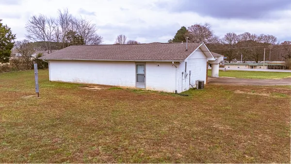 a view of a house with a yard and garage