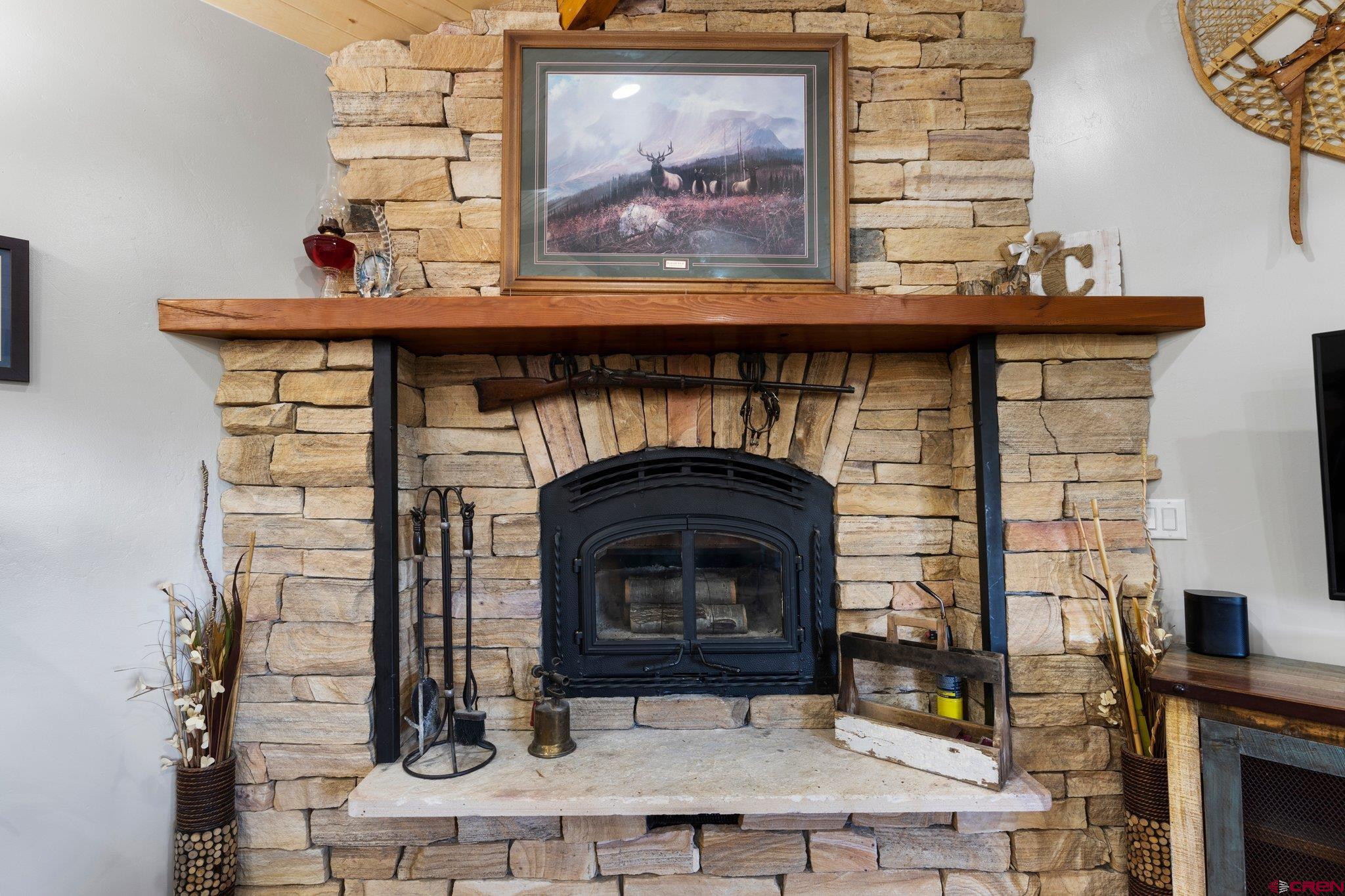 16132 Ee Road Pleasant View, CO 81331 - Photo 12 of 35 a fireplace with a clock on top of it